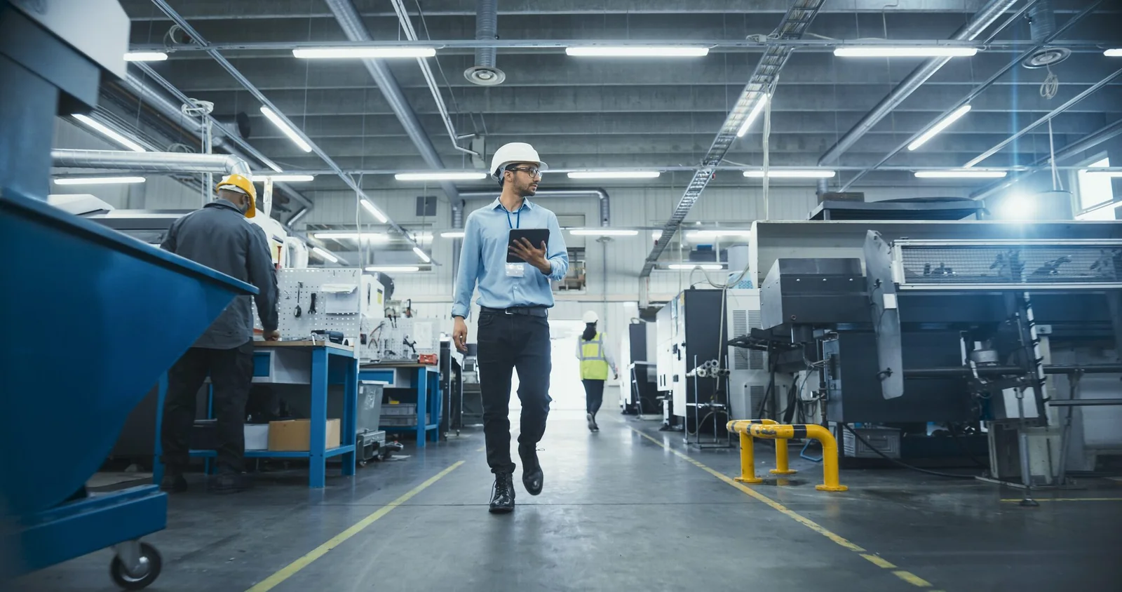 Engineer walking the factory floor with a tablet