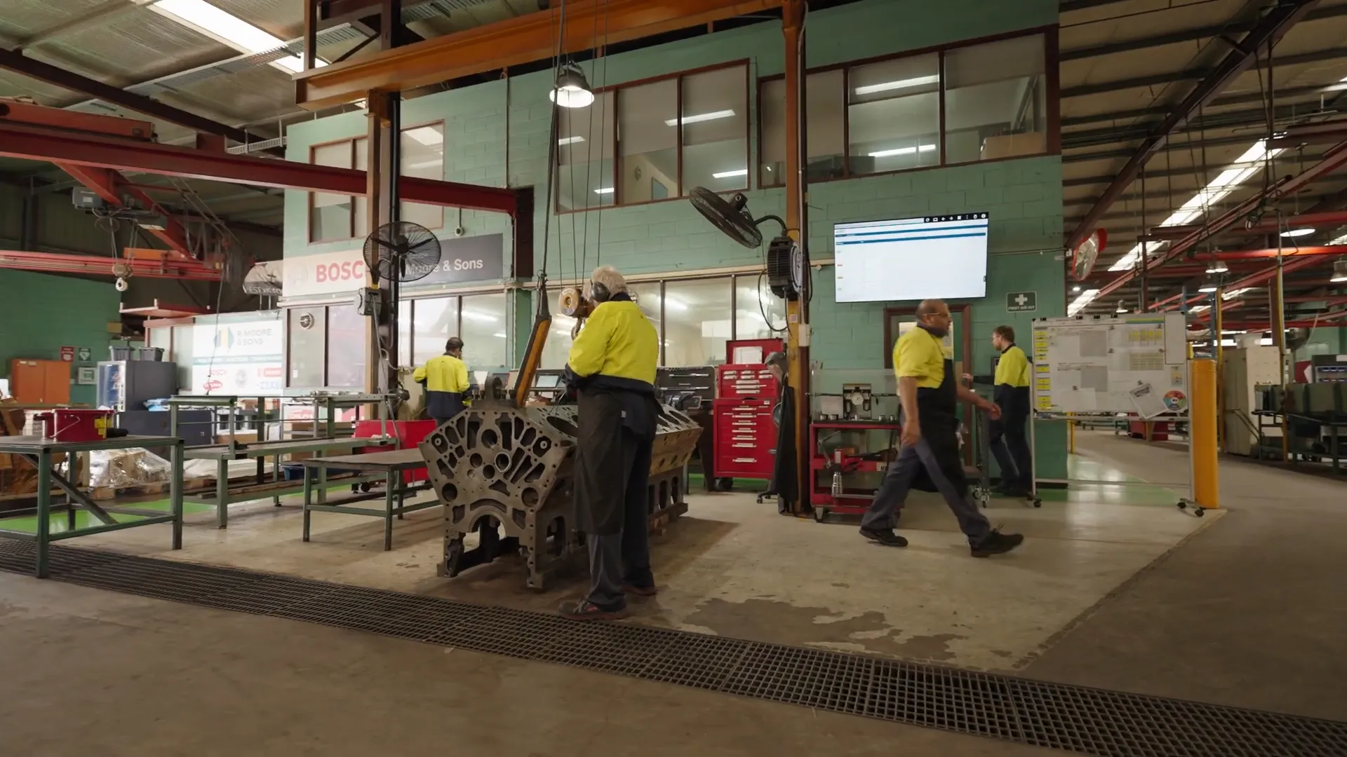 Operators on the shop floor with digital production board
